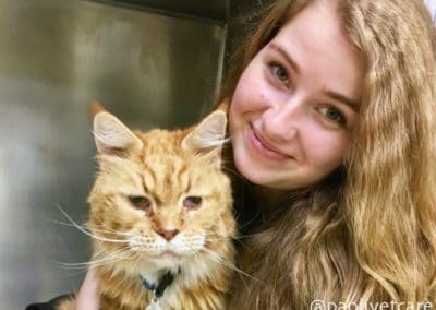 Kennel Assistant Kimberly with a vomiting cat