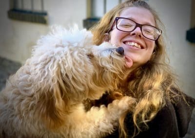 White Dog Licking Womans Face