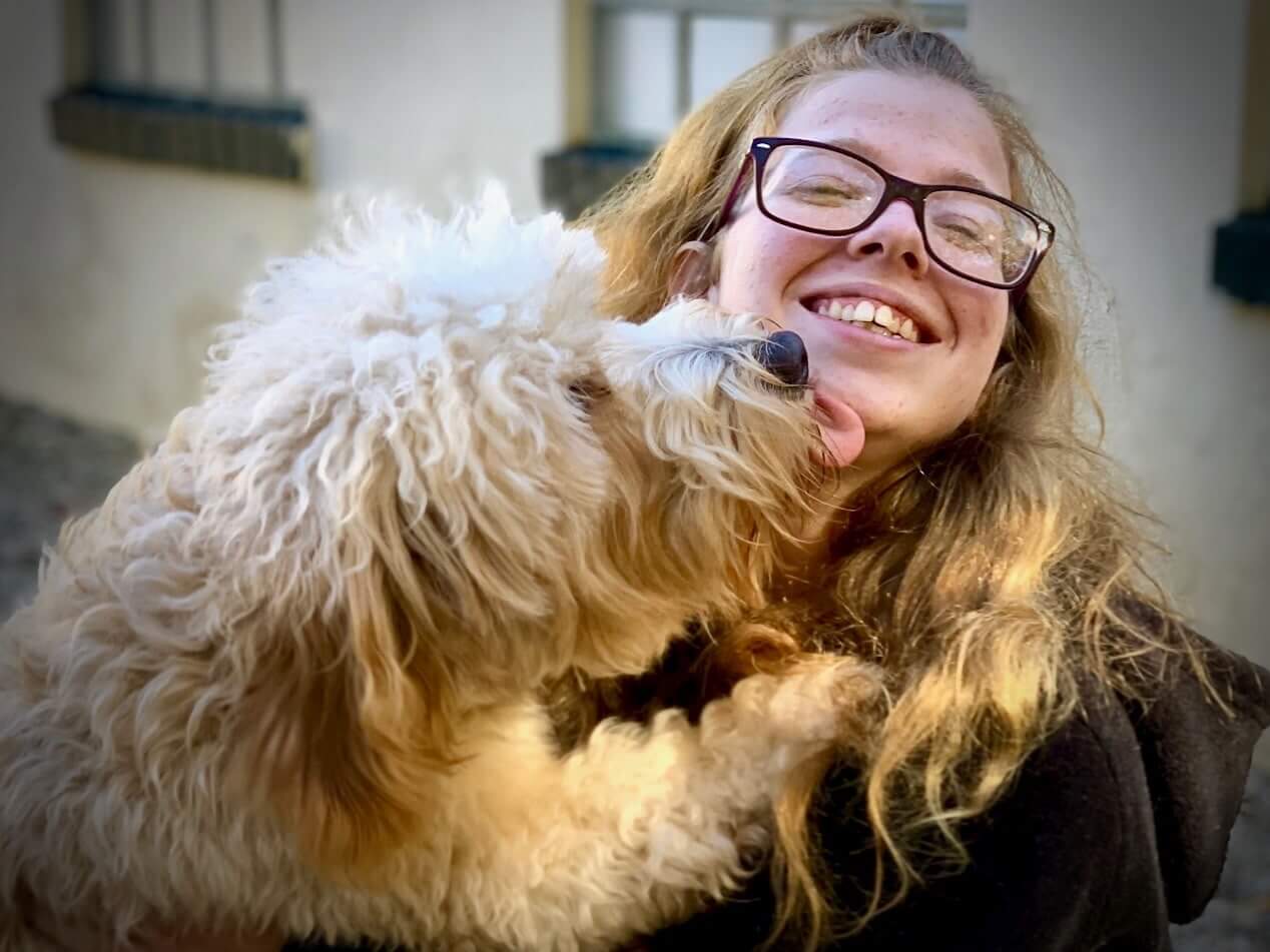 White Dog Licking Womans Face