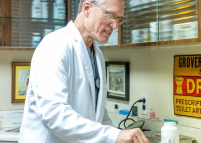 Dr. Rowan Counting Pills in his Pharmacy