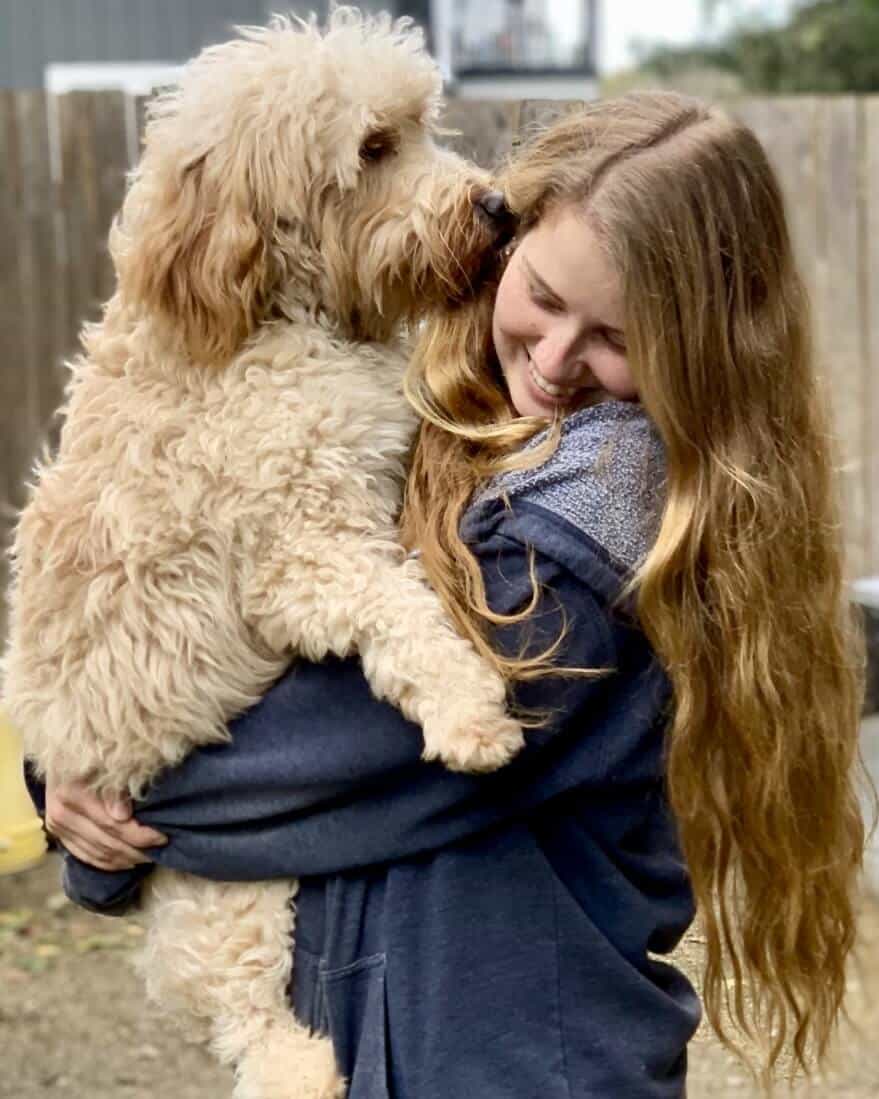 Kim holding a dog boarding